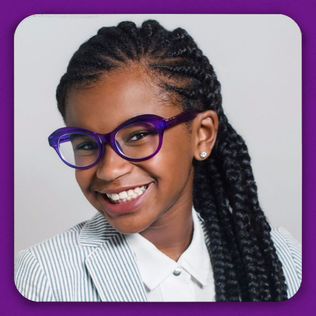 A smiling black girl in some stylish purple glasses
