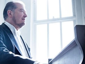 photo pf pianist in suit playing piano