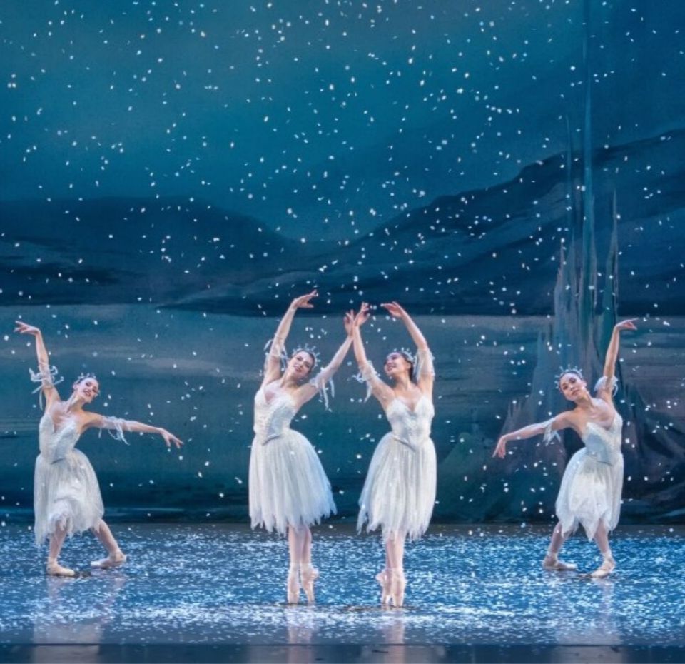 Dancers on a snowy stage.