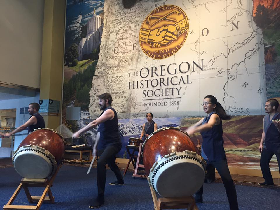 Taiko in front of an OHS sign