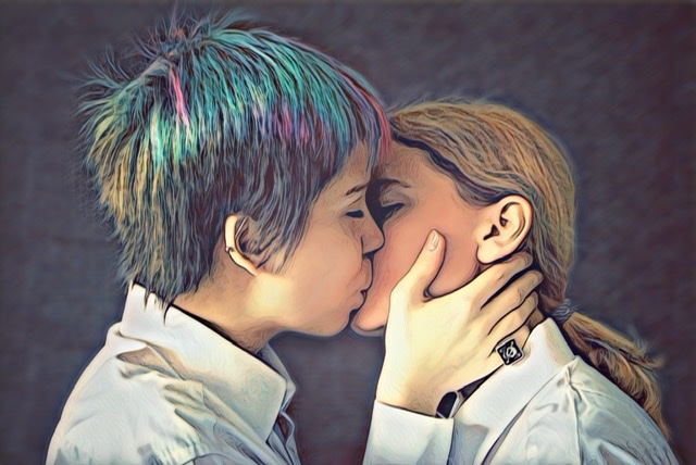 Stylized photo of two newlyweds kissing. One has short gender neutral hair cut and colorful hair dye. 