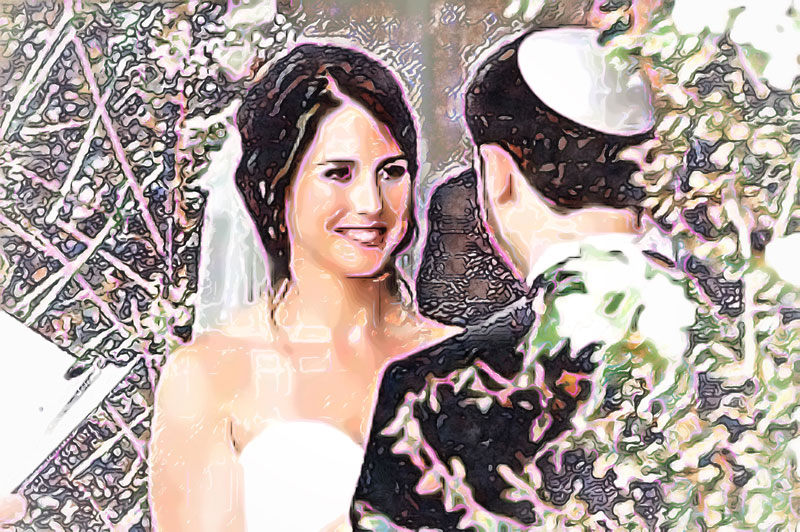 A bride and groom smile at each other during the Jewish wedding ceremony. The bride has a veil and white dress, the groom wears a kippah, yarmulke, and a black suit