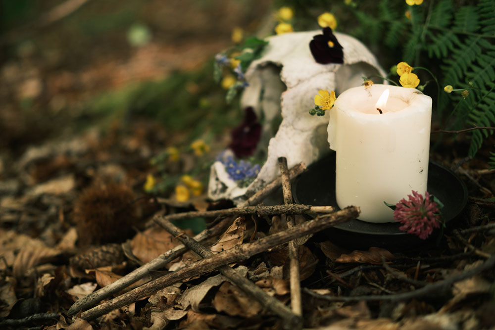 a wedding altar with pentagram, flowers, offerings, for pagan wedding handfasting ceremony