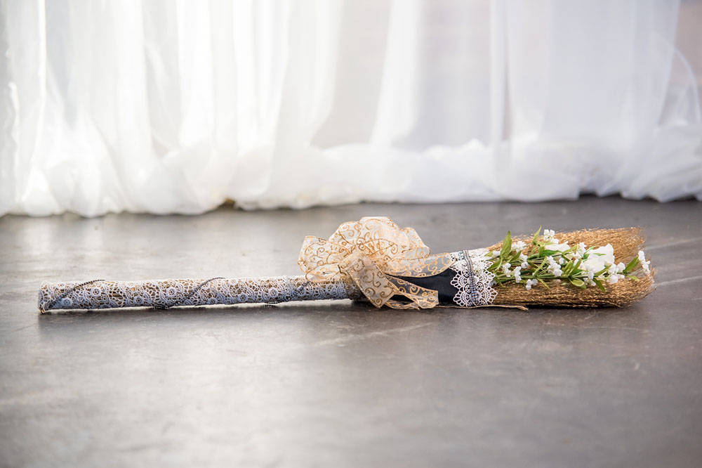 A wedding broom on the floor, decorated for the wedding day and the jumping the broom wedding tradition unity ritual
