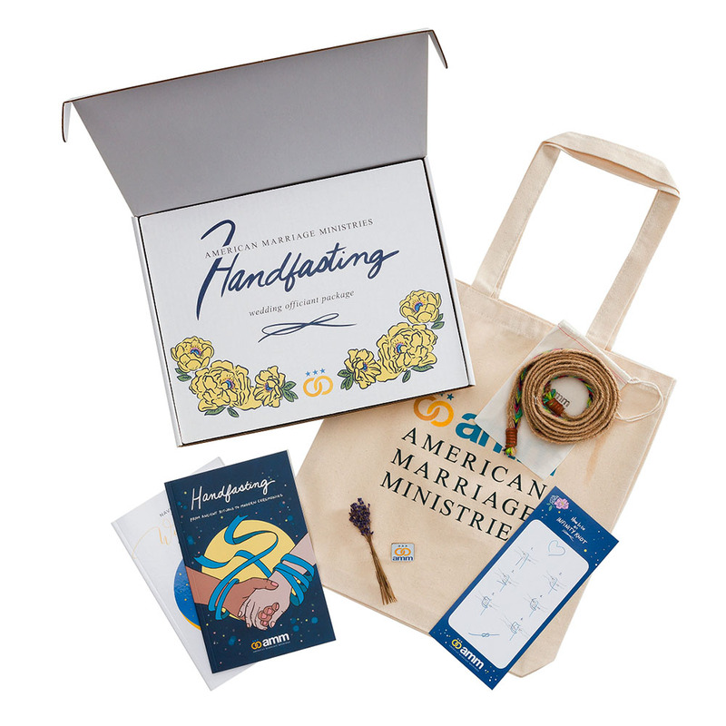 An interior shot of the Handfasting Wedding Officiant package, showing two planning guide books, a handfasting cord, a sprig of lavender, illustrated instructions on how to tie a handfasting knot infinity knot, and an enamel pin