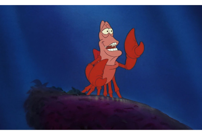 A screenshot from Disney's The Little Mermaid, showing Sebastian the crab standing against a blue background ... under the sea
