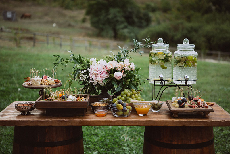 An outdoor cheese table for wedding, with a beautiful water urn