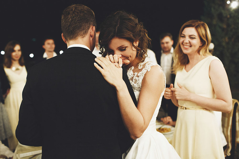 a young couple dance during an evening wedding reception 