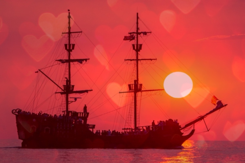 PIrate ship with a collage of red hearts in the background