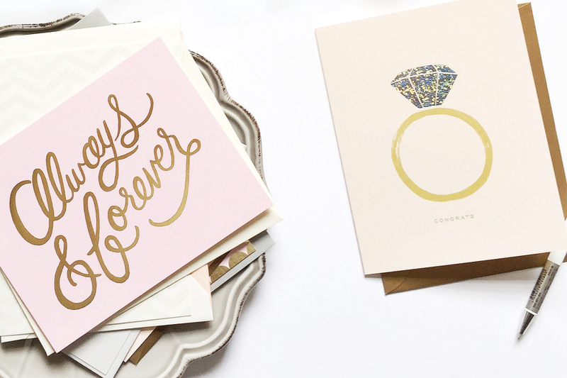 Close up photo of note cards and greeting cards with a pen.