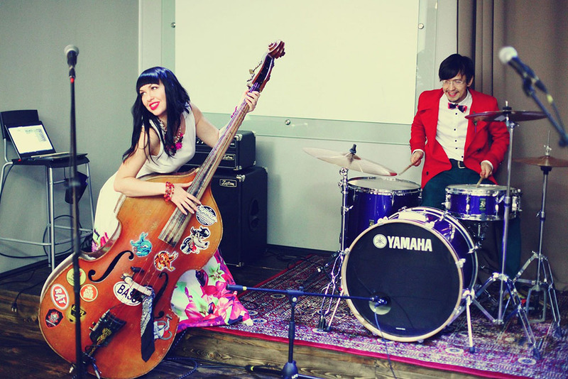 Bride and groom play upright bass and drums on their wedding day