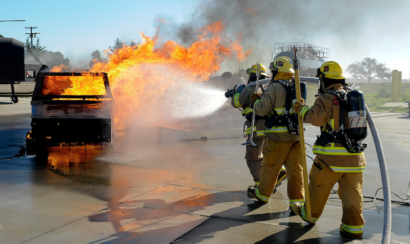 Firefighters put out a car fire