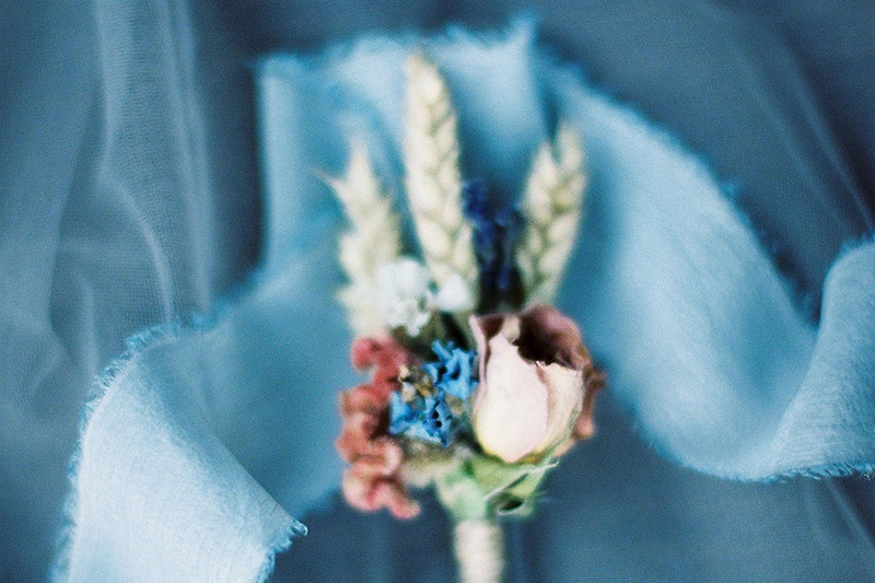 a blue handfasting ribbon and roses