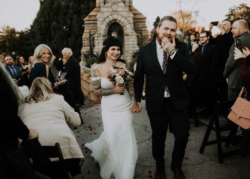 A newly married couple with happy friends and family at oakland cemetery in atlanta, georgia