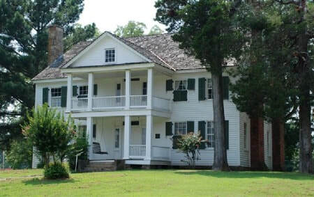 White two story building with columns, the historic Potts Inn Museum in Pope County Arkansas