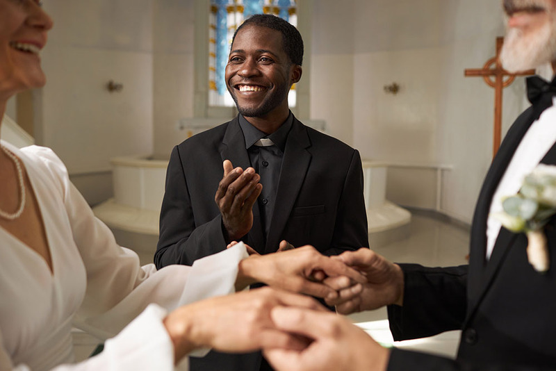 A young officiant leads a hand blessing ceremony during a vow renewal 