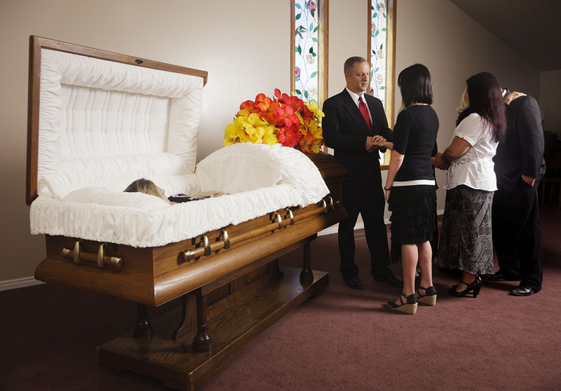 Open casket funeral service, the officiant greets family and friends of the deceased