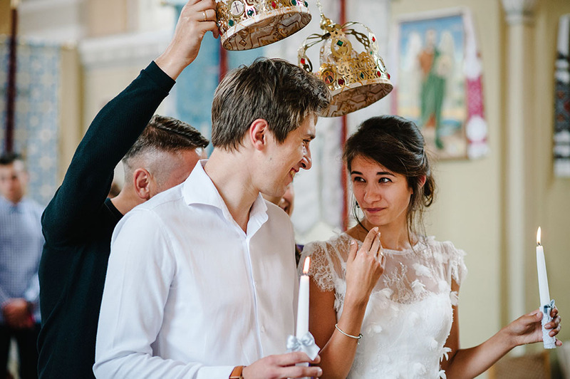 Wedding crowns are placed on the bride and grooms head during an Eastern Orthodox wedding marriage ceremony 