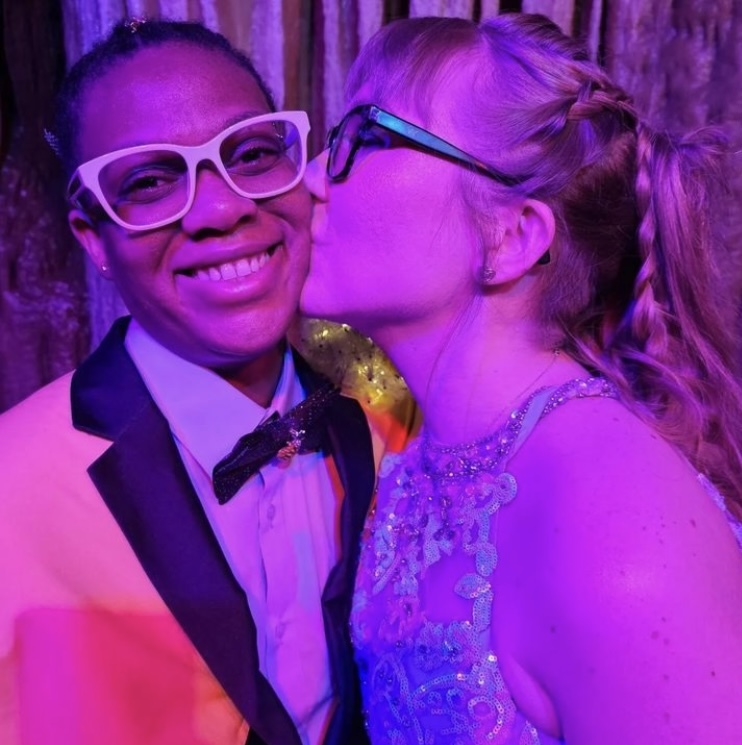 Brides Beka and Laura pose for a sweet wedding photo