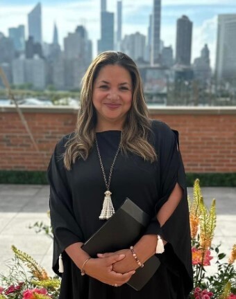 Photo of wedding officiant Rev Dr Samora Smith standing on a rooftop in NYC