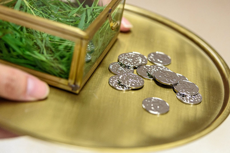 Close up photo showing unity coins for a wedding ceremony