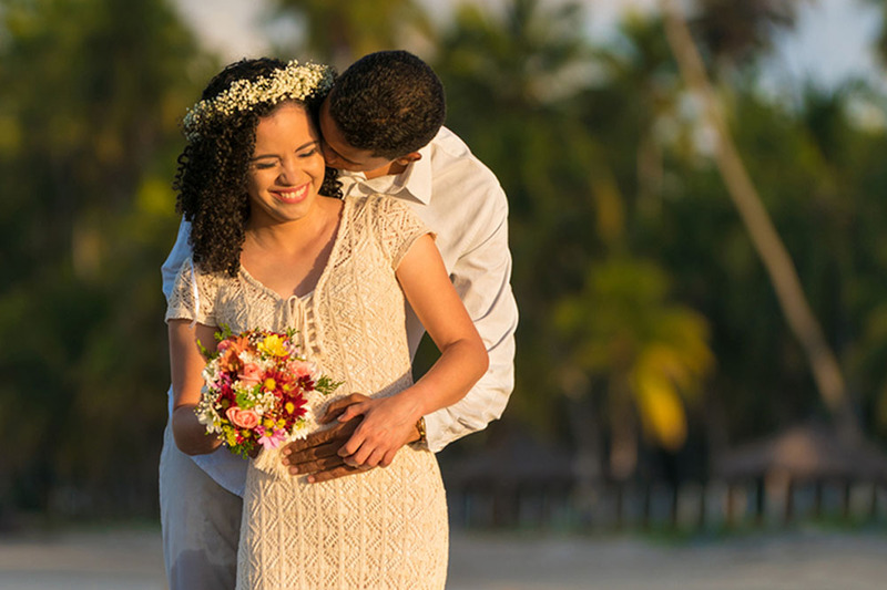 bride and groom embrace on a tropical beach 