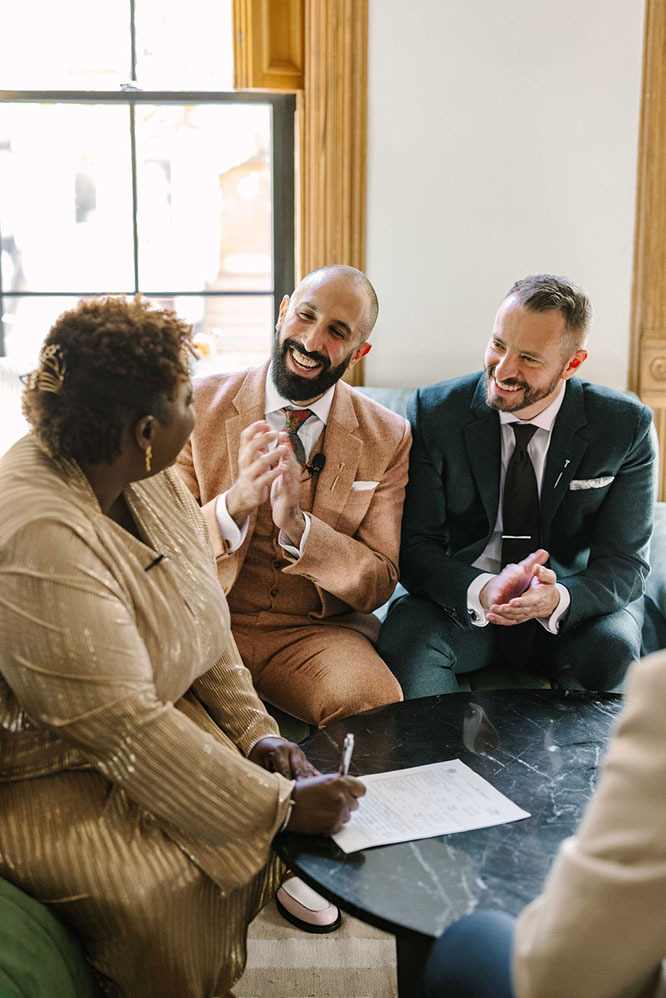 Lauren signs marriage paperwork with Barry and Jordan on the wedding day