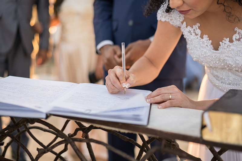 Newlywed signs the marriage license after the wedding ceremony