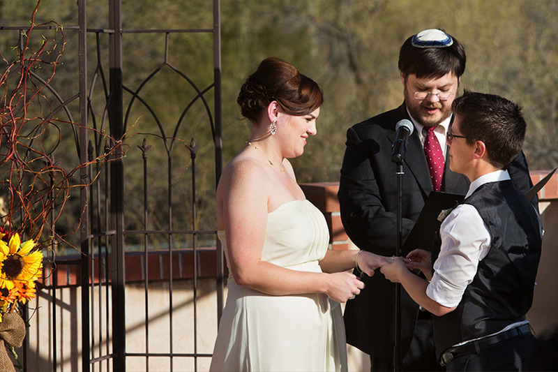 Jewish couple is married by the officiant during an outdoor wedding
