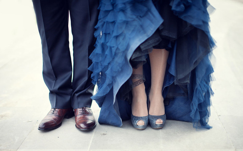 Close up of a bride in blue wedding dress and groom in blue suit