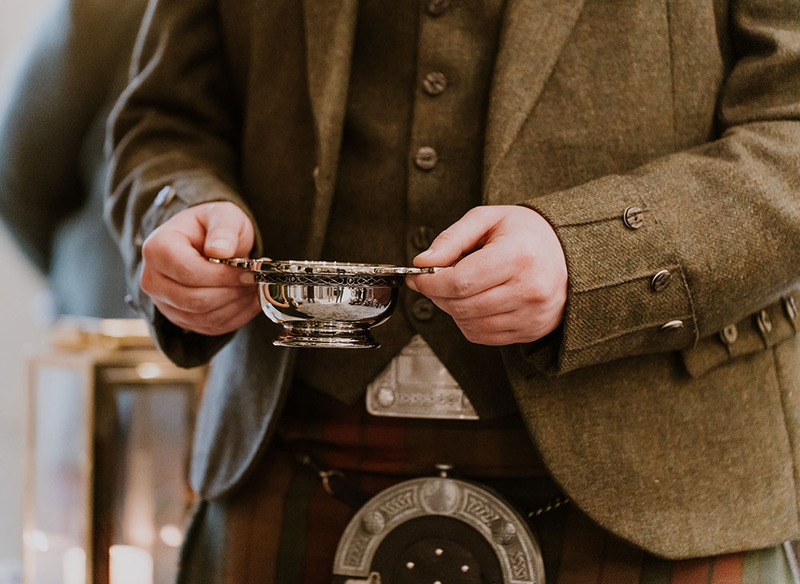 Close up of a man carrying the wedding quaich during a Scottish wedding