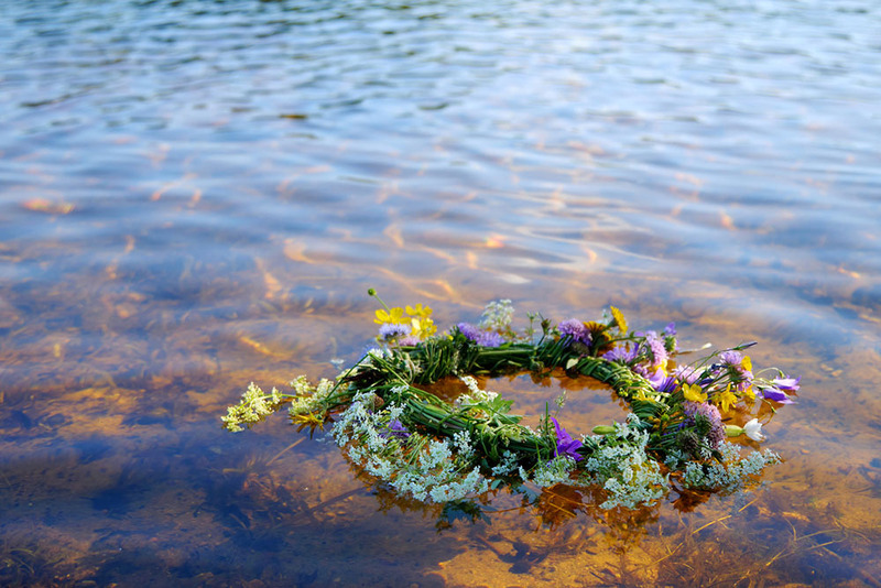 Close up of a wedding wreath of flowers floating in a beautiful river