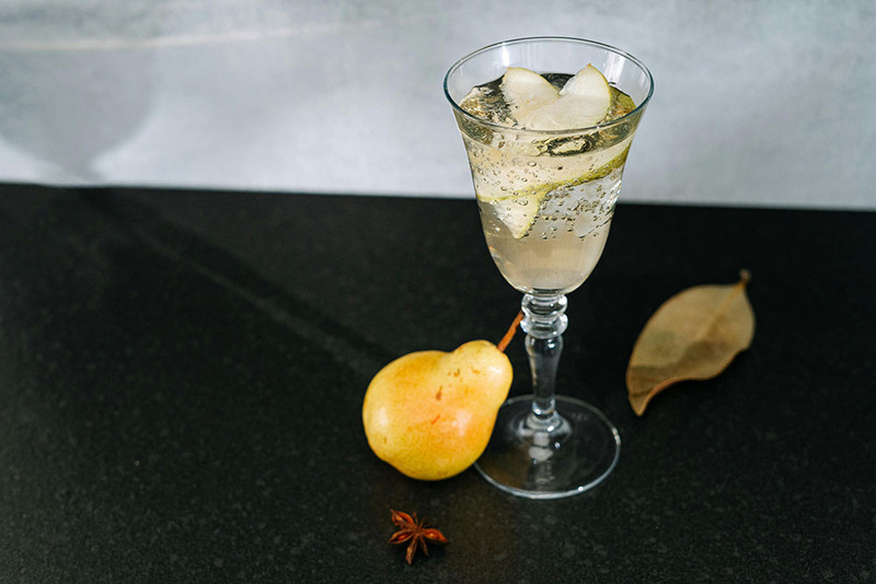 Photo of a fall wedding cocktail or mocktail, with pear and bubbles