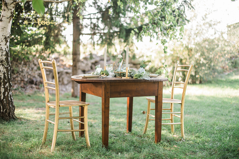 An outdoor wedding reception celebration meal table set up in a park.