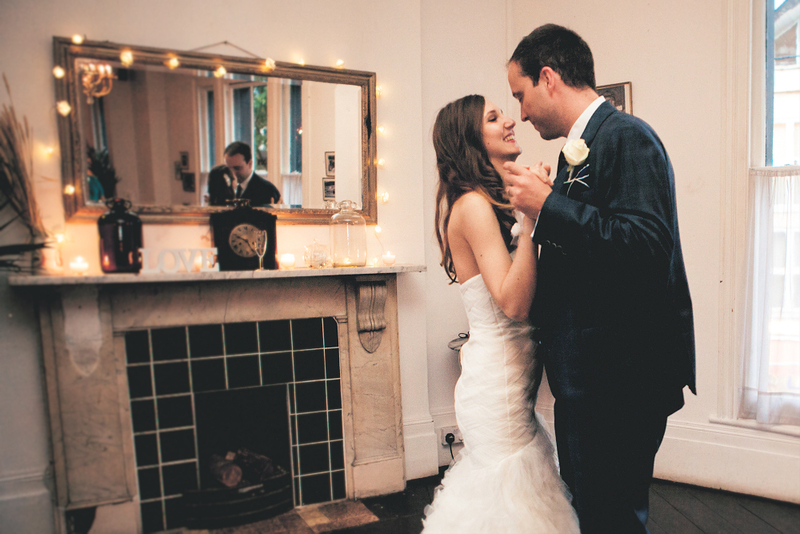 A happy couple dances during their indoor minimony elopement ceremony during Coronavirus COVID-19 pandemic