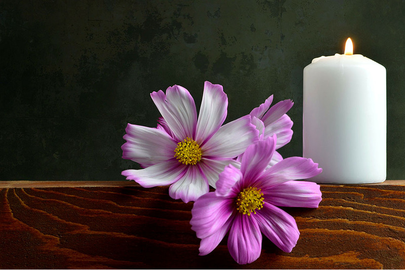 A candle and flower arranged at a memorial service