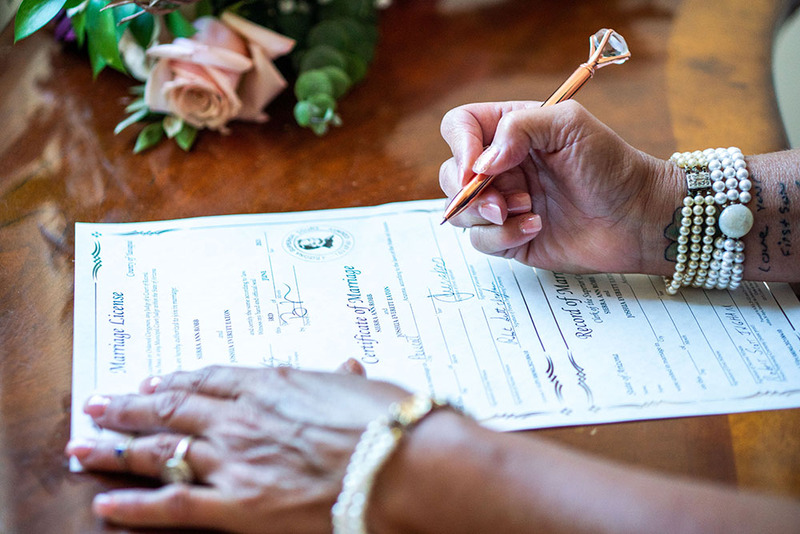 A woman signs the marriage license at a wedding