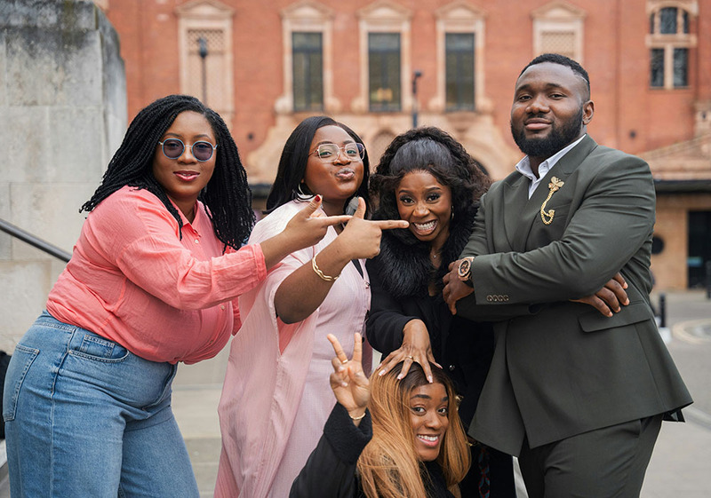 Guests pose with the groom outside the wedding venue
