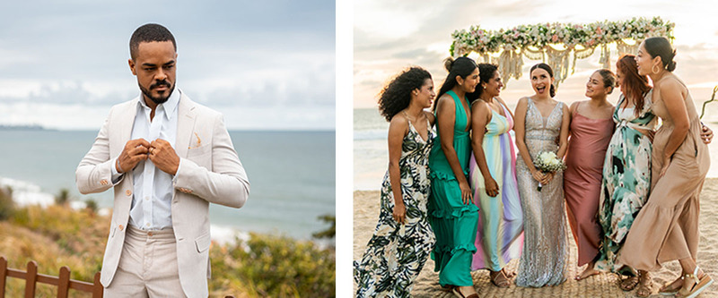 a man in a light colored linen suit, and wedding guests in long flowy dresses standing next to a bride on the beach