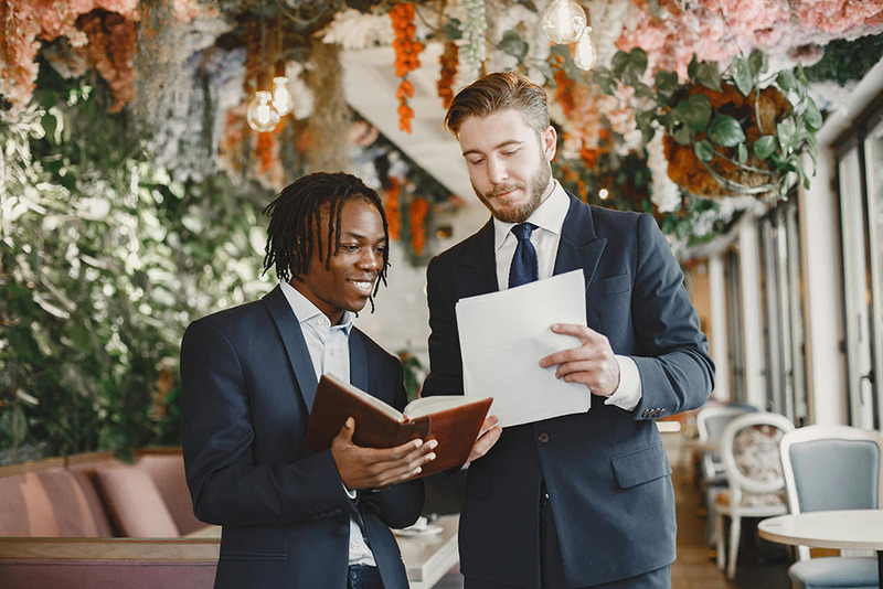 Wedding officiant and groom look at the script and readings before the ceremony