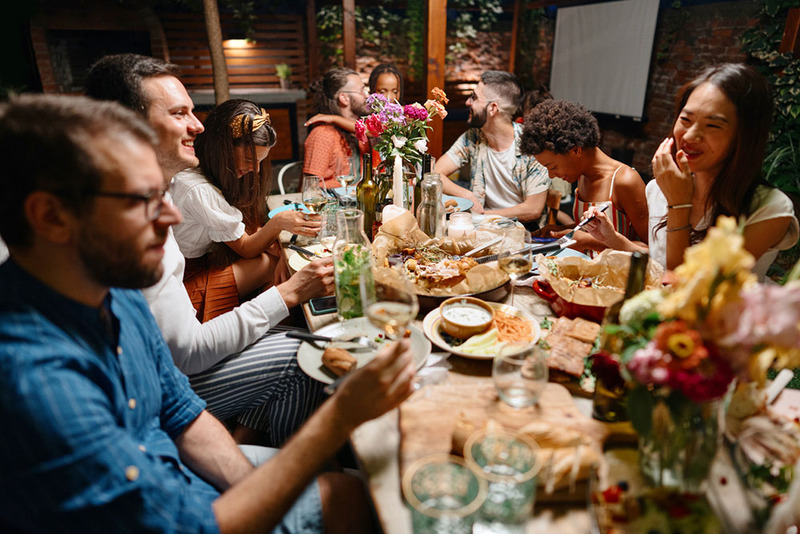 newlyweds and friends enjoy a meal