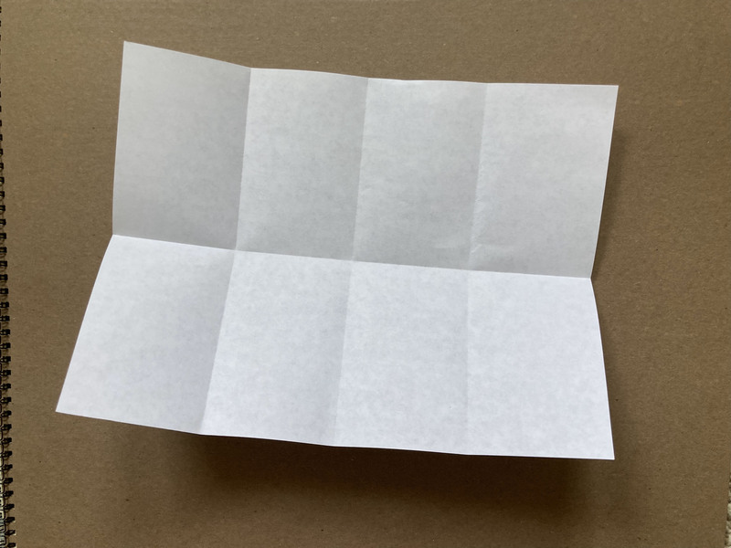 how to fold a zine, paper is folded with eight equal sections defined by creases