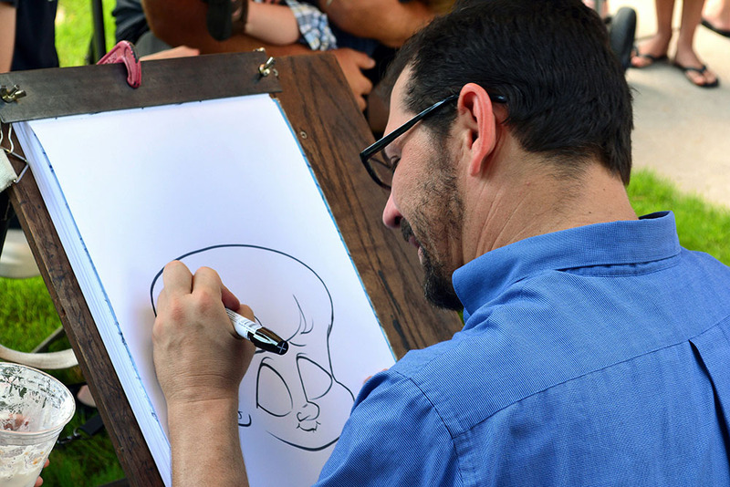 Wedding caricaturist draws during a celebration