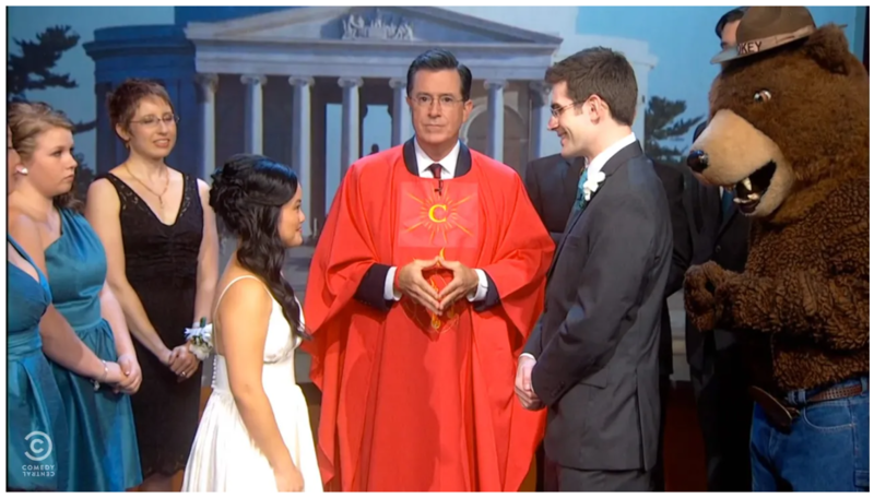 Screenshot from the Colbert Report, of Stephen Colbert performing a wedding live