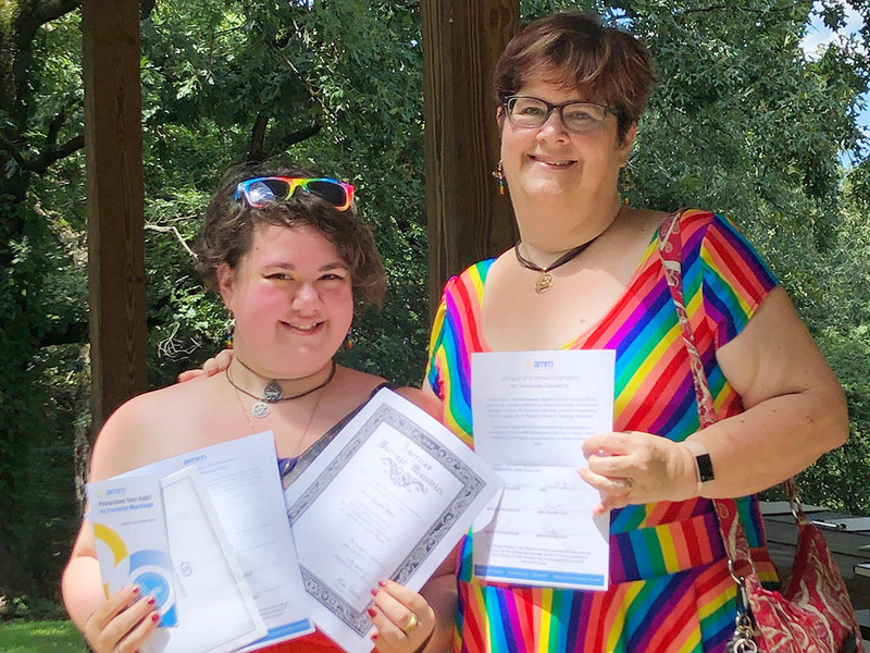 Two ministers show off their AMM ordination materials in Memphis TN