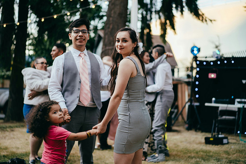 Friends stand outside during a wedding ceremony