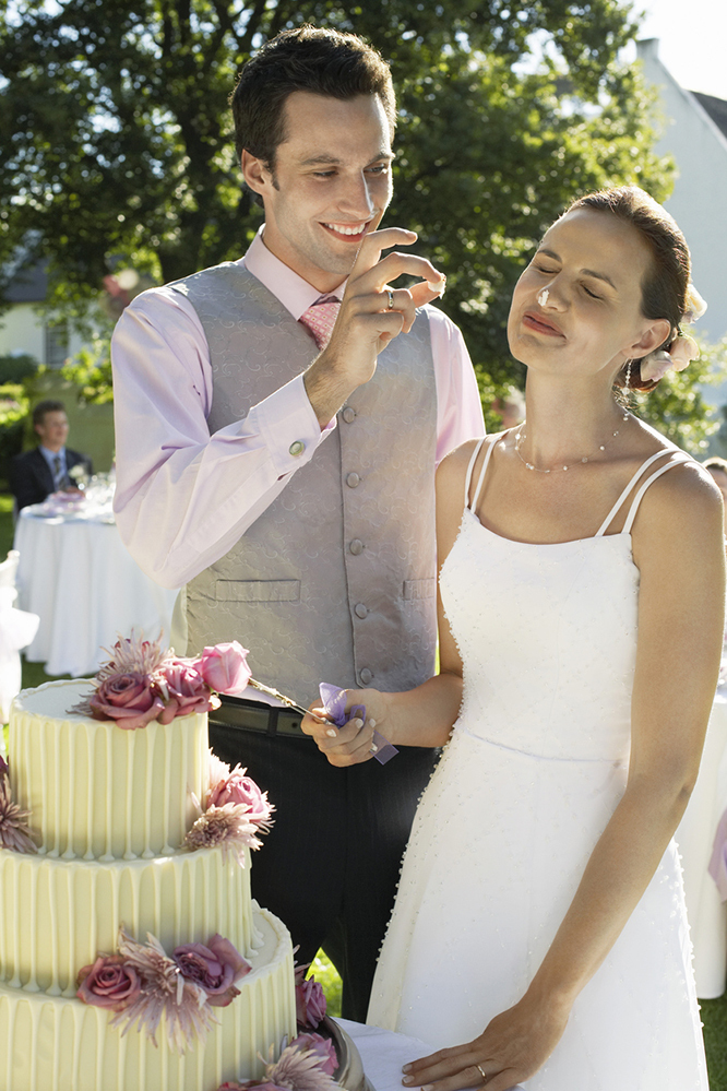 Groom smears cake on bride's nose