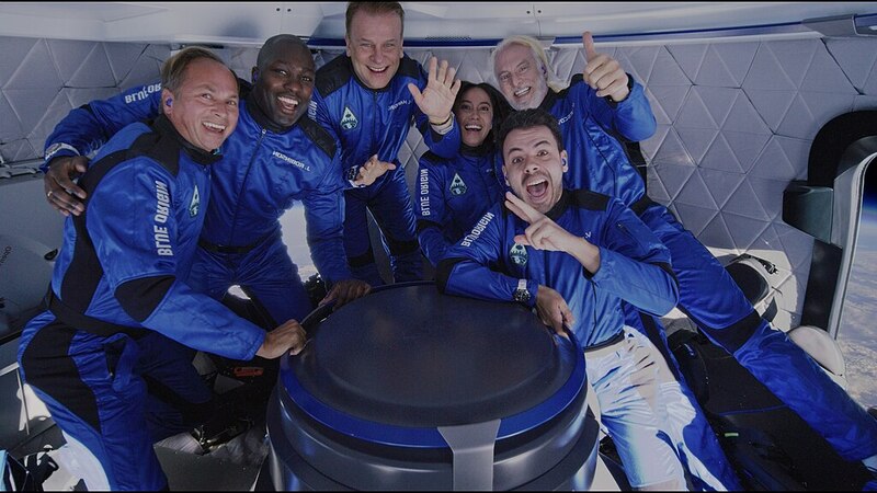 Crew member pose for a photo aboard a New Shepard rocket