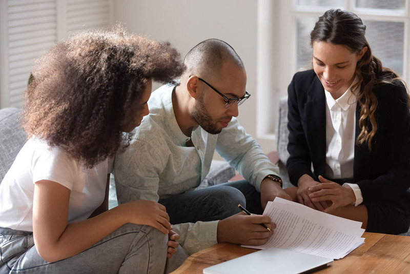 Couple looks over a prenup agreement with a lawyer