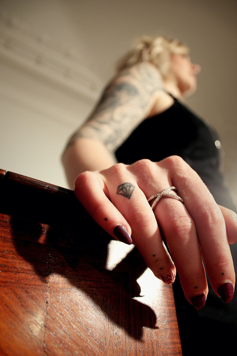 Stylized photo of young woman with a small diamond finger tattoo